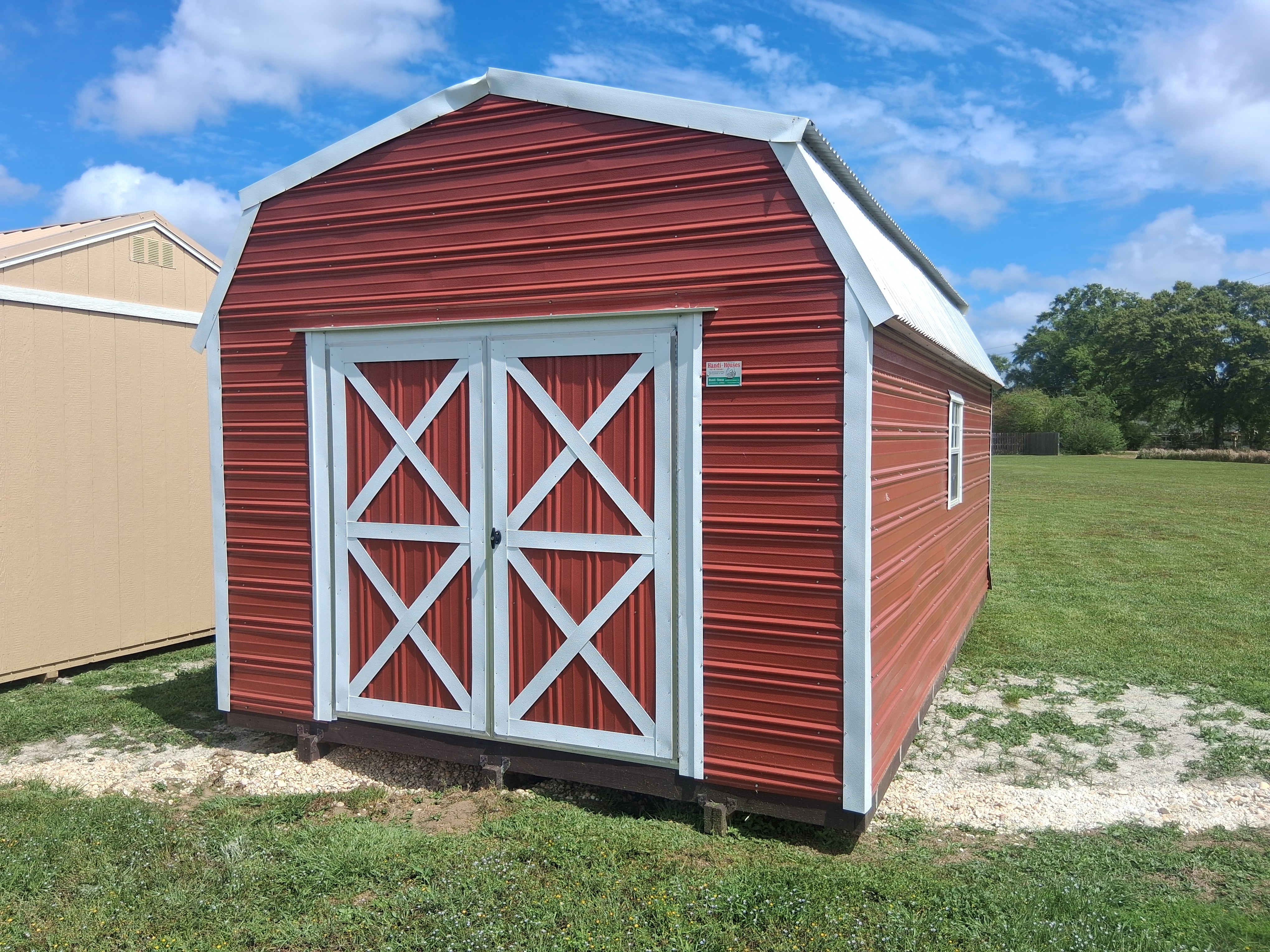 Red portable barn building in a field
